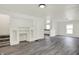 Open living room featuring built-in shelving, modern gray floors, and staircase at 952 N Concord St, Indianapolis, IN 46222