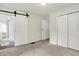 Cozy main bedroom featuring a barn door leading to the bathroom and closet at 952 N Concord St, Indianapolis, IN 46222