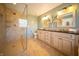 Bathroom featuring a glass shower and double sinks at 10120 Fox Trce, Zionsville, IN 46077