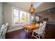 Dining area with a wood table set by a bright window bringing in natural light at 10120 Fox Trce, Zionsville, IN 46077
