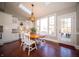 Bright dining area features wood floors, large windows, and a skylight for a sunny space at 10120 Fox Trce, Zionsville, IN 46077