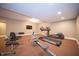 Brightly lit exercise room featuring an elliptical, treadmill, and weight training equipment at 10120 Fox Trce, Zionsville, IN 46077