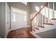 Bright foyer with hardwood floors and a staircase, illuminated by natural light through transom windows at 10120 Fox Trce, Zionsville, IN 46077