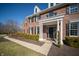 Charming front entrance with a black door framed by white columns and manicured hedges at 10120 Fox Trce, Zionsville, IN 46077