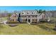 Stunning two-story brick home featuring black shutters, dormer windows, and manicured landscaping at 10120 Fox Trce, Zionsville, IN 46077