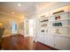 Hallway with built-in bookshelves, providing ample storage and display space at 10120 Fox Trce, Zionsville, IN 46077