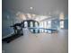 A large, bright indoor pool with a high ceiling, arched windows, and exercise equipment at 10120 Fox Trce, Zionsville, IN 46077