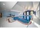 Spacious indoor pool with a tiled floor, vaulted ceiling, and multiple windows for ample light at 10120 Fox Trce, Zionsville, IN 46077