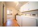 Laundry room with white cabinets and sink, and direct access to an additional room at 10120 Fox Trce, Zionsville, IN 46077