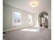Bright, carpeted room with two large windows and views of stairs and hallways at 10120 Fox Trce, Zionsville, IN 46077
