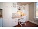 Bright and modern office nook with white cabinetry, granite counters, and a built-in desk at 10120 Fox Trce, Zionsville, IN 46077