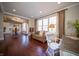 Open sitting room with natural light, connecting to the kitchen and breakfast nook at 10120 Fox Trce, Zionsville, IN 46077