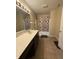 Bathroom featuring tan tiled floors, single sink vanity and tub with shower curtain at 10419 Dark Star Dr, Indianapolis, IN 46234