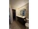 Well-lit bathroom features tile floor, dark vanity, and bright mirror lighting fixture at 10419 Dark Star Dr, Indianapolis, IN 46234