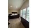 Bedroom featuring vaulted ceilings, neutral carpet and walls, bed, dresser, side tables and windows at 10419 Dark Star Dr, Indianapolis, IN 46234