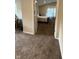 Bedroom featuring neutral colored carpet and walls, bed, window and dark wood trim at 10419 Dark Star Dr, Indianapolis, IN 46234