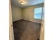 This bedroom features neutral paint, carpet, and a window with blinds at 10419 Dark Star Dr, Indianapolis, IN 46234
