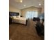Bedroom featuring vaulted ceilings, neutral carpet and walls, bed, dresser, and curtains at 10419 Dark Star Dr, Indianapolis, IN 46234