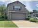 Inviting two-story house showcasing a neat front lawn and a practical two-car garage, in a Gathering-friendly neighborhood at 10419 Dark Star Dr, Indianapolis, IN 46234