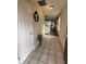 Welcoming foyer with neutral tile flooring, a decorative mirror, and a view leading to the staircase and living areas at 10419 Dark Star Dr, Indianapolis, IN 46234