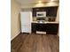 Kitchen with white refrigerator and dark cabinets at 10419 Dark Star Dr, Indianapolis, IN 46234