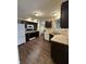 Well-lit kitchen features stainless steel appliances, dark cabinetry and wood-look flooring at 10419 Dark Star Dr, Indianapolis, IN 46234