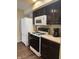 Functional kitchen with essential appliances and dark cabinets at 10419 Dark Star Dr, Indianapolis, IN 46234