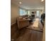 Open living room layout featuring fireplace, wood floors, and large sofa at 10419 Dark Star Dr, Indianapolis, IN 46234