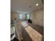 View of carpeted upstairs loft area with desk, two windows and white railing and two white doors at 10419 Dark Star Dr, Indianapolis, IN 46234