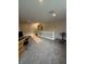 View of upstairs carpeted loft area with desk, stationary bike, neutral walls and lighting at 10419 Dark Star Dr, Indianapolis, IN 46234
