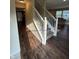 Elegant staircase featuring white railings and a blend of hardwood and carpeted steps, leading to the upper level at 10419 Dark Star Dr, Indianapolis, IN 46234