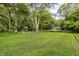 Spacious backyard featuring a fire pit with chairs, shed, and lush greenery at 11710 Prairie Pl, Carmel, IN 46033