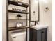 Small bathroom showcasing modern fixtures, a mirror, and decorative shelving with greenery at 11710 Prairie Pl, Carmel, IN 46033