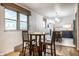 Cozy dining area with hardwood floors, bright windows, and seamless flow to the modern kitchen at 11710 Prairie Pl, Carmel, IN 46033