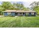 Charming single story home with blue brick, complemented by a lush green lawn and beautiful landscaping at 11710 Prairie Pl, Carmel, IN 46033