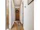 Bright hallway featuring hardwood floors and doors with decorative wreath accents at 11710 Prairie Pl, Carmel, IN 46033