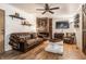 Cozy living room with a brick fireplace, leather sofa, and rustic decor creating a warm atmosphere at 11710 Prairie Pl, Carmel, IN 46033