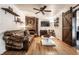 Comfortable living room features a leather sofa, brick fireplace, and wooden accents, creating a warm, inviting space at 11710 Prairie Pl, Carmel, IN 46033