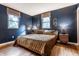 Serene bedroom with hardwood floors, two windows, and stylish decor at 11710 Prairie Pl, Carmel, IN 46033