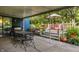 Covered outdoor patio and deck featuring a grill, patio furniture, and natural surroundings at 11710 Prairie Pl, Carmel, IN 46033