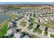 Aerial perspective showcases a community with numerous houses, a pond, and green spaces at 12650 Sunrise Dr, Noblesville, IN 46060