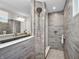 Modern bathroom with a glass enclosed shower, dual shower head, and gray wood-look tile at 12650 Sunrise Dr, Noblesville, IN 46060