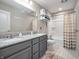 Bathroom featuring a double sink vanity with granite countertops and a shower-tub combo at 12650 Sunrise Dr, Noblesville, IN 46060