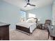 Comfortable bedroom with soft lighting, plush carpet, and a cozy rocking chair at 12650 Sunrise Dr, Noblesville, IN 46060