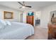 Well-lit bedroom featuring a comfortable bed, ceiling fan, and view of the bathroom, blending comfort and functionality at 12650 Sunrise Dr, Noblesville, IN 46060