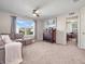 Cozy bonus room with comfortable seating, a ceiling fan, and natural light, perfect for relaxation and entertainment at 12650 Sunrise Dr, Noblesville, IN 46060