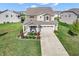 Stunning two-story home featuring a well-manicured lawn and a charming front porch seating area at 12650 Sunrise Dr, Noblesville, IN 46060