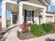 Inviting front porch with cozy seating, complemented by lush landscaping and a welcoming entrance at 12650 Sunrise Dr, Noblesville, IN 46060
