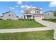 Charming two-story home showcasing a spacious lawn and a well-maintained exterior on a sunny day at 12650 Sunrise Dr, Noblesville, IN 46060