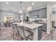 Gray kitchen with stainless steel appliances, quartz countertops, and a large center island with pendant lighting above at 12650 Sunrise Dr, Noblesville, IN 46060